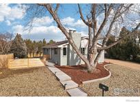 Updated ranch home exterior boasts a modern gray paint job, new landscaping, and a large tree at 1310 Toedtli Dr, Boulder, CO 80305