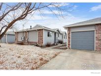 View of a house with a one-car garage and well kept grounds at 2027 Terry St # 1, Longmont, CO 80501