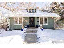 Charming single-story home featuring a dormer window and inviting front entry with steps and a snow-covered yard at 2424 4Th St, Boulder, CO 80304