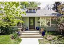 Charming home featuring a dormer window, gray roof, and inviting front porch with steps and plants at 2424 4Th St, Boulder, CO 80304