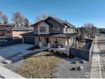 Charming two-story home featuring stone accents, a metal roof, covered front porch and well-maintained landscaping at 2700 15Th St, Boulder, CO 80304