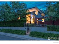 Modern home featuring unique architectural design, large windows, and mature trees at 303 Canyon Blvd # C, Boulder, CO 80302