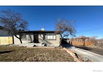 Charming single-story home with a well-maintained front yard and inviting curb appeal at 305 S Carr St, Lakewood, CO 80226