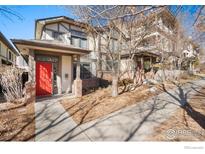 Charming two-story home featuring a bright red front door and inviting entrance at 33 Garfield St, Denver, CO 80206