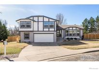 Charming two-story home with a well-maintained lawn, a two-car garage, and stylish black and white exterior accents at 4223 Peach Way, Boulder, CO 80301