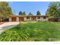 Ranch style home with attached two-car garage and landscaped yard at 5604 Bowron Pl, Longmont, CO 80503