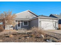 Gray ranch house with attached garage and landscaped yard at 622 Beth Ave, Fort Lupton, CO 80621