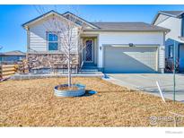 Ranch style home with landscaped yard and two-car garage at 6325 Copper Dr, Erie, CO 80516