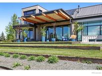 Modern home featuring a backyard with a covered patio and stunning landscaping at 635 Paragon Dr, Boulder, CO 80303