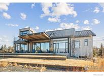 Modern home showcasing its unique architecture and expansive windows for natural light at 635 Paragon Dr, Boulder, CO 80303