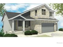 Two-story house with stone and gray siding, attached garage, and landscaping at 904 Eldorado Ln, Louisville, CO 80027