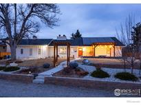 Updated Ranch home with a charming pergola, walkway, and mature landscaping at 14117 W 58Th Pl, Arvada, CO 80004