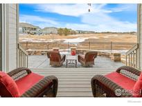 Inviting covered patio with comfortable seating, overlooks community open space perfect for outdoor relaxation and entertaining at 15813 Xanthia Way, Thornton, CO 80602