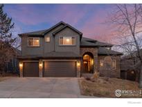 Two-story house with stone accents and a three-car garage at 19064 Eagle Ridge Dr, Golden, CO 80401