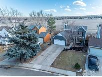 Aerial view of a charming house with a two-car garage and a spacious yard at 194 W Sycamore Ln, Louisville, CO 80027