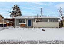 Gray exterior house with a snow covered front yard at 5332 Granby St, Denver, CO 80239