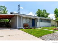 Charming single-story home with well-maintained lawn, covered carport, and welcoming blue front door at 5332 Granby St, Denver, CO 80239