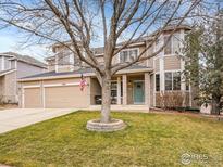 Two-story house with a landscaped lawn and attached two-car garage at 5508 Triple Crown Dr, Frederick, CO 80504