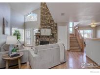 Spacious living room features a stone fireplace and hardwood floors at 5690 W 80Th Pl # 91, Arvada, CO 80003