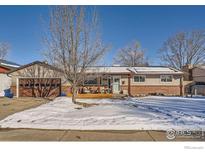 Beautiful ranch home with a spacious front yard, a large driveway, and a well-maintained lawn at 616 S Carr Ave, Lafayette, CO 80026