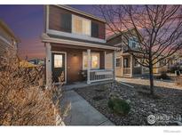 Charming two-story home featuring a cozy front porch and professionally landscaped front yard at 673 Country Road N Trl, Berthoud, CO 80513