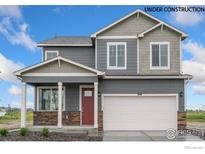 Two-story house with gray siding, red door, and a two-car garage at 824 Ledge St, Lochbuie, CO 80603