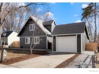 Charming home boasts a neat yard and a detached garage with a convenient driveway at 125 Telluride Pl, Longmont, CO 80504