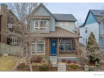 Two-story craftsman style home with a metal roof and stone accents at 1345 Snowberry Ln, Louisville, CO 80027