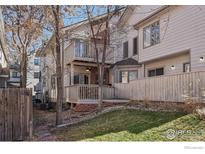 View of the backyard featuring a wooden deck, upper level patio and partial lawn area at 154 S Jackson St, Denver, CO 80209