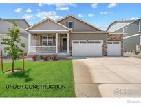 New construction home with two-car garage and landscaped front yard at 1866 Westport Ave, Berthoud, CO 80513