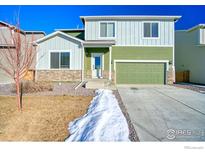 Two-story house with green and white siding, a two-car garage, and a landscaped yard at 2251 Kerry St, Mead, CO 80542