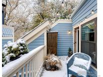 Cozy balcony with snow-covered furniture and string lights, perfect for winter evenings at 3025 Broadway St # 40, Boulder, CO 80304