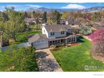 Well-manicured lawn and landscaping surround this charming two-story home at 4302 Apple Way, Boulder, CO 80301