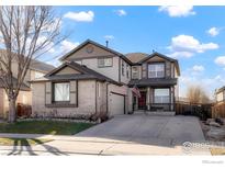 Charming two-story home with a manicured lawn, attached garage, and lovely curb appeal at 6433 Eagle Butte Ave, Frederick, CO 80516