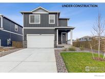 New construction home with two-car garage and landscaped yard at 847 Ledge St, Lochbuie, CO 80603