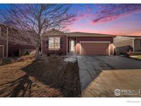 Attractive ranch home with a two-car garage and mature landscaping at 851 Lonewolf Cir, Lochbuie, CO 80603