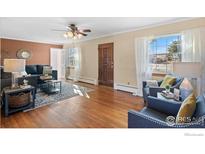 Inviting living room with hardwood floors, modern furnishings, and large windows for natural light at 860 S Garrison St, Lakewood, CO 80226