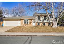 Ranch style home with attached garage and mature landscaping at 965 W Willow St, Louisville, CO 80027