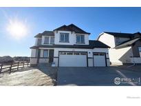 Beautiful two-story home featuring a two-car garage and manicured front yard at 16805 Mckay Dr, Mead, CO 80542