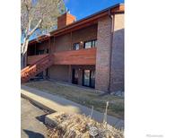 Brick two-story condo building with wood trim and a stairwell at 1961 Centennial Dr, Louisville, CO 80027