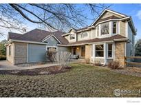 Charming two-story home with brick and siding and manicured lawn at 7202 Snow Peak Ct, Niwot, CO 80503