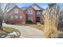 Charming brick home showcasing an extended driveway, mature trees, and tasteful landscaping at 7345 W 94Th Ave, Westminster, CO 80021