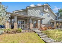 Charming two-story home features a covered front porch with brick pillars and a well-maintained lawn at 2900 Purcell St, Brighton, CO 80601