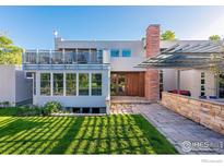 Stunning contemporary home featuring well-manicured lawn, modern architecture, and a spacious outdoor deck at 875 Dellwood Ave, Boulder, CO 80304