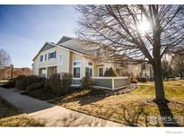 Inviting two-story home featuring lush landscaping, manicured lawn and mature trees at 930 Button Rock Dr # 102, Longmont, CO 80504