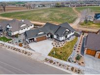 Beautiful ranch-style home with a three-car garage, mature landscaping and inviting curb appeal at 1291 Swan Peter Dr, Berthoud, CO 80513