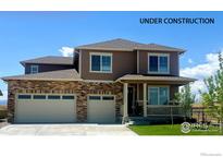 Beautiful two-story home with a brick and siding exterior and a three-car garage at 1860 Chaffee Crest Dr, Berthoud, CO 80513