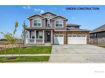 Under construction, this new two-story home features a three-car garage, stone accents, and a covered porch at 1876 Chaffee Crest Dr, Berthoud, CO 80513
