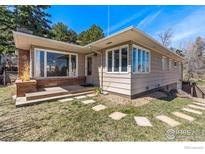 Single story home with large front windows, stone accent and a tidy front lawn at 2975 3Rd St, Boulder, CO 80304