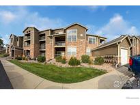 Beautiful apartment complex with manicured landscaping, neutral paint, and charming balconies at 3035 Blue Sky Cir # 10-207, Erie, CO 80516